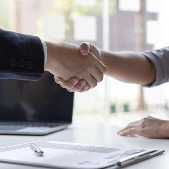 employer and interviewee shaking hands